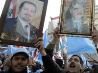 Holding up images of caretaker prime minister Saad Hariri (L) and his late father Rafiq (R) Lebanese supporters of the Future Movement.