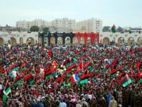 Thousands of Libyans celebrate during a ceremony announcing the liberation for the country in the eastern city of Benghazi  after ousted despot Moamer Kadhafi was captured and killed. A series of optimistic speeches by the new interim leaders ushered in the new age of Libya and paying tribute to the courageous efforts that got them to this point.