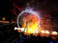 Fireworks light up The London Eye ferris wheel just after midnight in London, England.