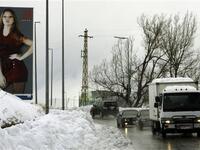 Traffic moves slowly in both directions on the main highway linking Beirut to Damascus near the mountain village of Sawfar during a snow storm which hit the Mediterranean country.