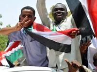 Sudanese wave their national flag as they celebrate in Khartoum after South Sudan proclaimed independence from the north, creating the world's newest nation and splitting Africa's largest country in two.