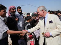 Prince Charles meets refugees at a camp