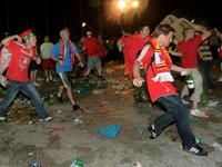 As for football hooliganism popularized by Brits at home and abroad, here shown, fans of Liverpool and AC Milan fight in the streets.Comparisons to be drawn with Liverpool's Hillsborough disaster. This mass crowd crush, killing fans, threw into relief the need for crowd control and better infrastructure to safeguard against such tragedy. 