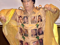 Proudly bearing his African 'kingdom's' heroes for all to get a closer look at. Leader of the African Union sports the ultimate Africa pride golden shirt marked in maps of the continent and faces of the Great Africans.