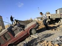 Palestinians inspect a destroyed Hamas compound after an Israeli strike overnight in Gaza City as Israel staged air raids in Gaza overnight, wounding 17 people.
