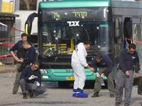 Israeli paramedics inspect the scene of an explosion next to a bus near Jerusalem's central bus station which left thirty people hurt
