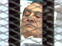 First outing to court, August 3rd, facing charges of conspiring to kill protesters: Mubarak presents a dramatic site for 
Tahrir eyes: Wheeled into court on a stretcher bed, in a metal cage, he is fitted out in
white pajamas, hospital gown and convalescent-like, a shadow of the Mubarak once-mighty,  now pale and meek, as the
patient-defendant..