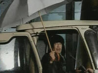 In the 1st speech of the month, most surreal appearance -blink and you might have missed it- in 15 second abbreviation of what could have been spun out had the weather conditions been right, he stands under an umbrella by his ‘Tuk Tuk’(rickshaw).