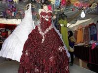 A woman looks at dresses in a covered stall in the northern Jordanian Zaatari refugee camp, now home to 160,000 Syrians (AFP)