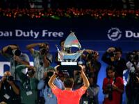 Stanislas Wawrinka of Switzerland poses with his trophy in front of journalists after beating Marcos Baghdatis of Cyprus in their ATP final tennis match of the Dubai Duty Free Tennis Championships on February 27, 2016. Wawrinka won 6-4, 7-6 (15/13). MARWAN NAAMANI / AFP