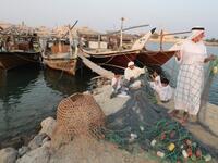 Emirati men train children on handicraft industries during the Dalma Sailing Festival. (KARIM SAHIB / AFP)