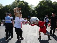 Protesters wearing masks depicting US President Donald Trump (L) and Britain's Prime Minister Theresa May (R) join other protesters against the UK visit of US President Donald Trump demonstrate outside Chequers, the prime minister's country residence, where Trump and May are holding a meeting. (Isabel INFANTES / AFP)