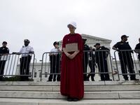 Payton Sander wearing a dress from The Handmaid's Tale protests at the steps of the US Supreme Court to protest against the appointment of Supreme Court nominee Brett Kavanaugh. (Jose Luis Magana / AFP)