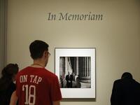 Visitors pause to look at a photograph of Sen. John McCain (R-AZ) on display at the Smithsonian National Portrait Gallery August 27, 2018 in Washington, DC. (AFP)