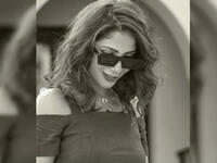 She added a thick bracelet, sunglasses and high heeled sandals as accessories