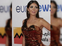 Mona showed up wearing a formal golden bronze dress on Al Gouna Film Festival red carpet 