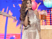 The second look of Nawal Al Zoghbi was a dress of a style that was popular this year with a soft hairdo