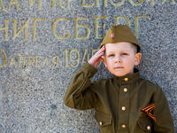 Little boy in military uniform with flowers at the military memorial of the Victory Day on May 9 in Russia, Kaliningrad , Victory Park, May 2018 (Shutterstock/File Photo)
