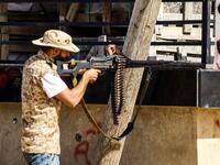 A Libyan fighter loyal to the Government of National Accord (GNA) aims a machine gun while taking during clashes with forces loyal to strongman Khalifa Haftar south of the capital Tripoli's suburb of Ain Zara, on April 10, 2019. Mahmud TURKIA / AFP