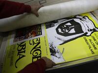 Abboudi Abu Jawdeh shows part of his vintage cinema poster collection at his office in the Lebanese capital Beirut  JOSEPH EID / AFP