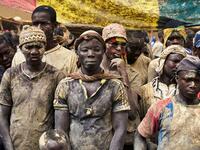 People take part in the annual rendering of the Great Mosque of Djenne in central Mali  MICHELE CATTANI / AFP