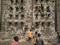 People take part in the annual rendering of the Great Mosque of Djenne in central Mali  MICHELE CATTANI / AFP
