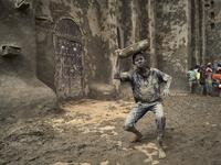 A man takes part in the annual rendering of the Great Mosque of Djenne in central Mali  MICHELE CATTANI / AFP