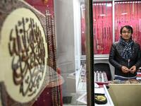 Hadi Ekhlas, engraver, poses for a picture in his workshop at the Grand Bazaar in Istanbul.  OZAN KOSE / AFP