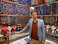 Expert Afghan jeweler Khalil Nuri poses for a picture in his shop at the Grand Bazaar in Istanbul.   OZAN KOSE / AFP
