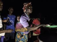 South Sudanese Refugees receive food after being transported from the border of South Sudan and the Democratic Republic of the Congo (DRC) to a refugee settlement site  JOHN WESSELS / AFP
