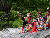 In a remote valley in Pakistan dozens of Kalash minority women dance to celebrate spring's arrival -- but as a gaggle of men scramble to catch them on camera, the community warns an influx of domestic tourists is threatening their unique traditions.  AAMIR QURESHI / AFP