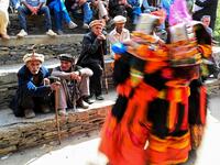 In this picture  Kalash elderly men watch women dancing as they celebrate 'Joshi', a festival to welcome the arrival of spring, at Bumburate village in the mountainous valleys in northern Pakistan.  AAMIR QURESHI / AFP