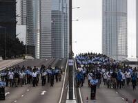 Police arrive to negotiate with protesters to clear a road in Hong Kong early.  ISAAC LAWRENCE / AFP