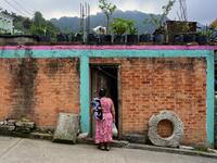 Mexican artisan Glafira Candelaria Jose, 59, of the Otomi ethnic group, stands outside her house in San Nicolas Village, in Tenango de Doria, Hidalgo state, Mexico.  Pedro PARDO / AFP