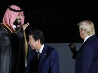 US President Donald Trump (R) and Saudi Crown Prince Mohammed bin Salman (L) gesture next to Japan's Prime Minister Shinzo Abe (C) and his wife Akie as they pose for a group photo during the G20 Summit in Osaka on June 28, 2019.  Dominique JACOVIDES / POOL / AFP