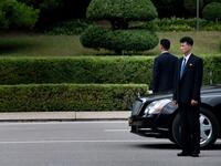 Members of North Korean security stands guard near a North Korean motorcade while US President Donald Trump and North Korea's leader Kim Jong-un meet in the Demilitarized Zone(DMZ) on June 30, 2019.  Brendan Smialowski / AFP