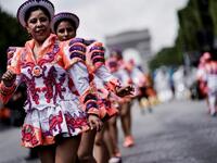 People parade during the Tropical Carnival on July, 7 2019 in Paris.  Kenzo TRIBOUILLARD / AFP