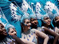 People parade during the Tropical Carnival on July, 7 2019 in Paris.  Kenzo TRIBOUILLARD / AFP