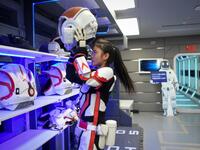 A guide wearing a spacesuit puts on a helmet at "Mars Base 1", a C-Space Project, in the Gobi desert, some 40 kilometres from Jinchang in China's northwest Gansu province on April 17, 2019. WANG ZHAO / AFP