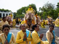 Elephants under the command of their mahouts bow with well-wishers during a procession near the Grand Palace to pay their respects to Thailand's King Maha Vajiralongkorn in Bangkok on May 7, 2019.  Jewel SAMAD / AFP