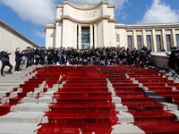 Members of the action group Extinction Rebellion (XR) spill fake blood on the steps of the Trocadero esplanade during a demonstration to alert on the state of decline of biodiversity, on May 12, 2019 in Paris. FRANCOIS GUILLOT / AFP