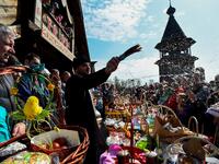 An Orthodox priest blesses traditional cakes and eggs on the eve of Orthodox Easter at Saint Petersburg's Pokrovsky Cathedral on April 27, 2019.  Olga MALTSEVA / AFP