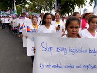 Workers march along a street to mark International Labour Day in Phnom Penh on May 1, 2019.  TANG CHHIN Sothy / AFP