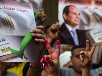 Egyptian people show their inked hands after voting at a polling station during the third day of a referendum on constitutional amendments, at a school in shamma village in the northern Nile delta province of Menoufia, on April 22, 2019.  Mohamed el-Shahed / AFP