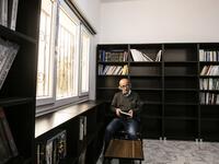 Ziad al-Hamad, director of the first cultural centre to open since ISIS rule ended in the eastern Syrian city of Raqa. He holds a book as he sits in its library on May 1, 2019. Delil souleiman / AFP