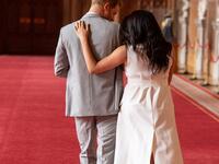 Britain's Prince Harry, Duke of Sussex (L), and his wife Meghan, Duchess of Sussex, walk away after posing for photographs with their newborn baby son, Archie Harrison Mountbatten-Windsor, in St George's Hall at Windsor Castle in Windsor, west of London on May 8, 2019.  Dominic Lipinski / POOL / AFP