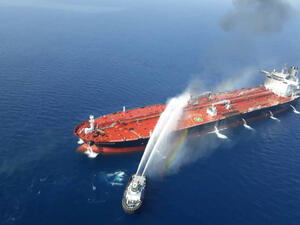 An Iranian navy boat tries to stop the fire of an oil tanker after it was attacked in the Gulf of Oman. 