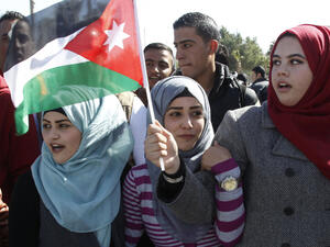 Jordanian girls wave the flag of Jordan.