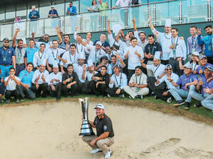 Graeme McDowell celebrates victory, with volunteers in the background. (Supplied)