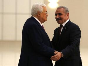 Palestinian Authority President Mahmoud Abbas (L) shakes hands with the prime minister Mohammad Shtayyeh in the West Bank city of Ramallah, on April 13, 2019. (Abbas Momani/AFP)